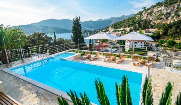 Private pool and sun loungers with parasols on the terrace of a luxury Dubrovnik villa for family vacation