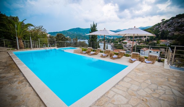 Private pool and sun loungers with parasols on the terrace of a luxury Dubrovnik villa for family vacation