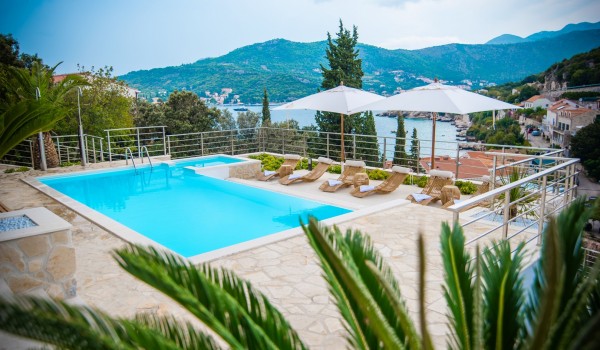 Private pool and sun loungers with parasols on the terrace of a luxury Dubrovnik villa for family vacation