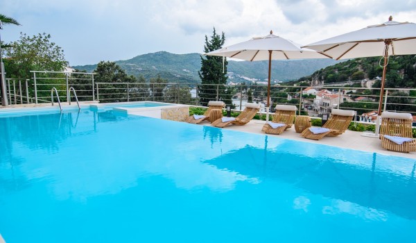 Private pool and sun loungers with parasols on the terrace of a luxury Dubrovnik villa for family vacation