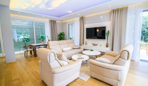 Living room with comfortable sofas and dining table in a luxury Dubrovnik villa with private parking and wifi