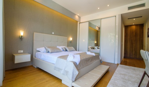 King size bed in an elegant bedroom of a luxury vacation villa Grandiosa with private pool and parking