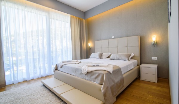 King size bed in an elegant bedroom of a luxury vacation villa Grandiosa with private pool and parking