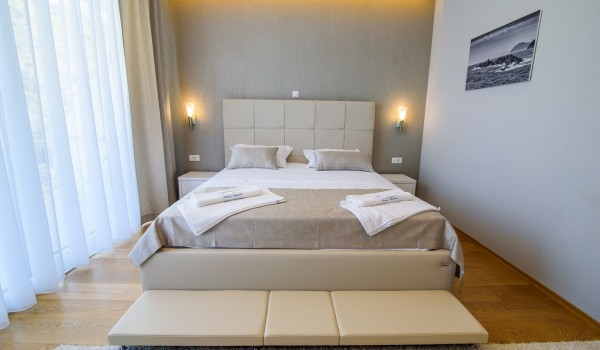 King size bed in an elegant bedroom of a luxury vacation villa Grandiosa with private pool and parking