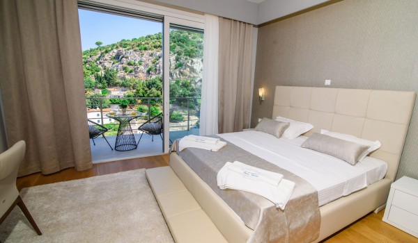 King size bed in an elegant bedroom of a luxury vacation villa Grandiosa with private pool and parking