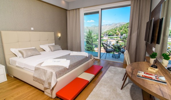 King size bed in an elegant bedroom of a luxury family villa with private pool and parking