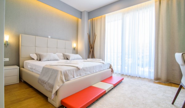 King size bed in an elegant bedroom of a luxury family villa with private pool and parking