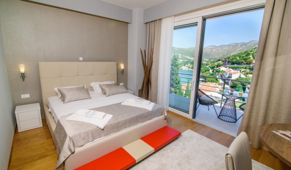 King size bed in an elegant bedroom of a luxury family villa with private pool and parking