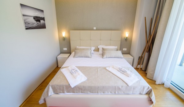 King size bed in an elegant bedroom of a luxury family villa with private pool and parking