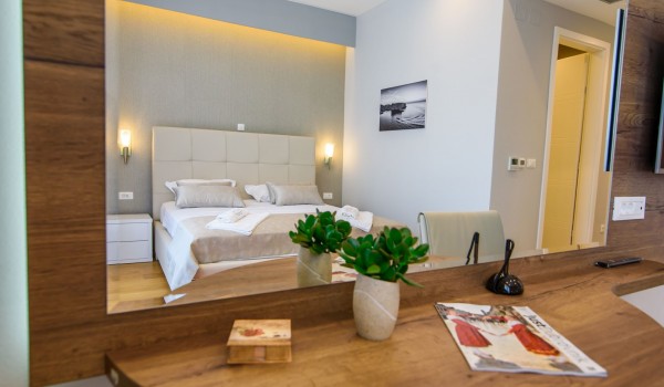 King size bed in an elegant bedroom of a luxury family villa with private pool and parking
