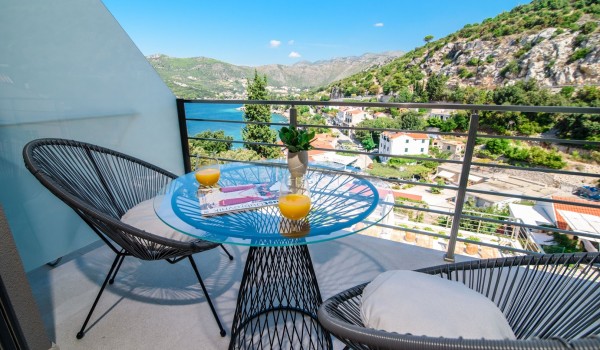 Seating area on the private bedroom balcony of a luxury family villa with private pool and sea view