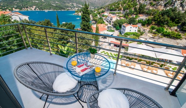 Seating area on the private bedroom balcony of a luxury family villa with private pool and sea view
