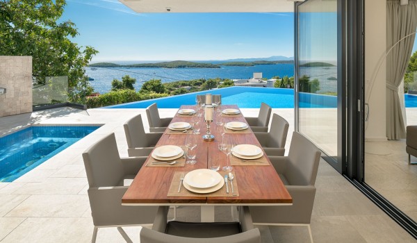 Private terrace of the Croatian luxurious family villa Hvar Fantasy with dining area and heated pool for rent and vacation