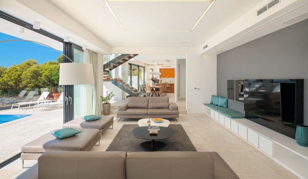 Lounge area with the big smart TV and sofas with direct exit to terrace with heated pool and the sea view in luxury villa Hvar Fantasy