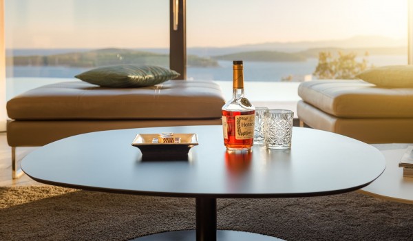 Lounge area with the big smart TV and sofas with direct exit to terrace with heated pool and the sea view in luxury villa Hvar Fantasy