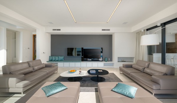 Lounge area with the big smart TV and sofa with direct exit to terrace with heated pool and the sea view in luxury villa Hvar Fantasy