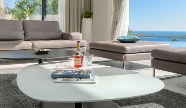 Lounge area with the big smart TV and sofas with direct exit to terrace with heated pool and the sea view in luxury villa Hvar Fantasy