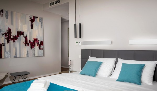 Bedroom with the king size bed and the lounge chair in the luxurious villa Hvar Fantasy for vacation with family and friends