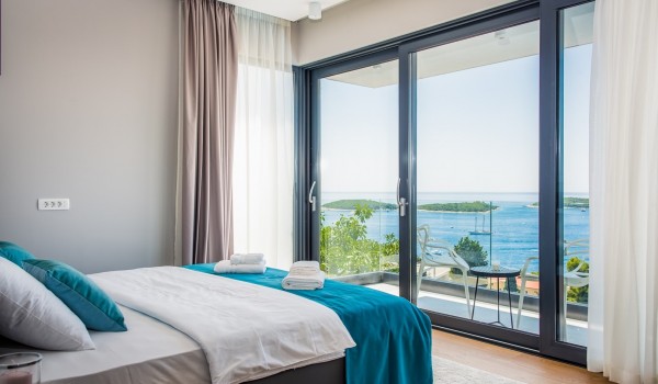 Beach front Croatia luxury villa Hvar Fantasy with the bedroom and the private balcony overlooking the sea for vacation with family and friends