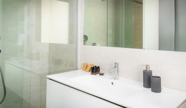 Modern bathroom of the luxury family villa Hvar Fantasy with the sink and the shower cabin for vacation and rent