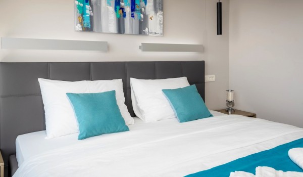 Bedroom of the luxurious villa Hvar Fantasy with the king size bed and the reading corner for relaxing vacation for family and friends in Hvar