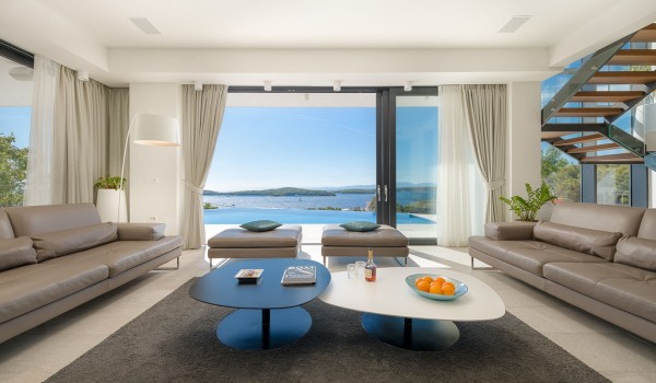Lounge area with the big smart TV and sofa with direct exit to terrace with heated pool and the sea view in luxury villa Hvar Fantasy