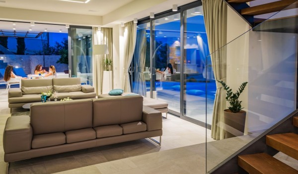 Living room area with the direct exit to the private terrace with heated pool in the luxurious villa Hvar Fantasy for vacation and rent