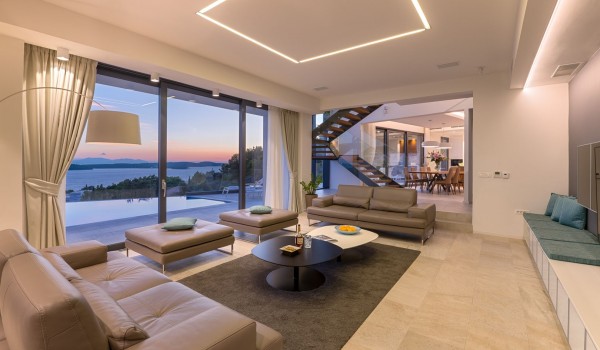 Lounge area with the big smart TV and sofa with direct exit to terrace with heated pool and the sea view in luxury villa Hvar Fantasy