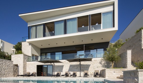 View of Croatia luxury holiday villa with private pool surrounded by deckchairs for rent with friends
