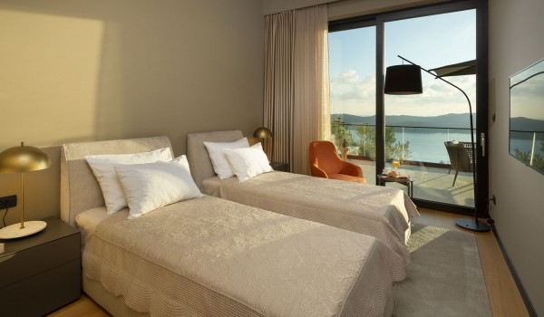 Bedroom of luxury Croatia seafront villa Elena with two single beds and private balcony for vacation