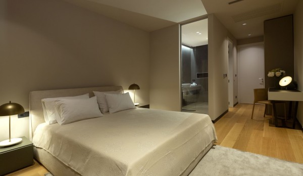Master bedroom of Croatia luxury pool villa with king-size bed and private bathroom for family vacation