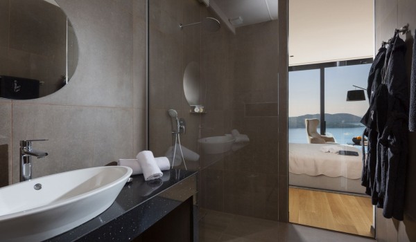 Modern bathroom of Croatia luxury seafront villa with shower cabin and sink with mirror for vacation