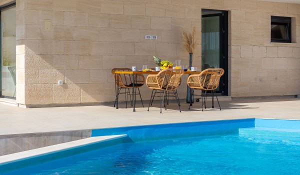 Outdoor dining area near pool of holiday luxury villa Azul in Makarska for vacation and rent.