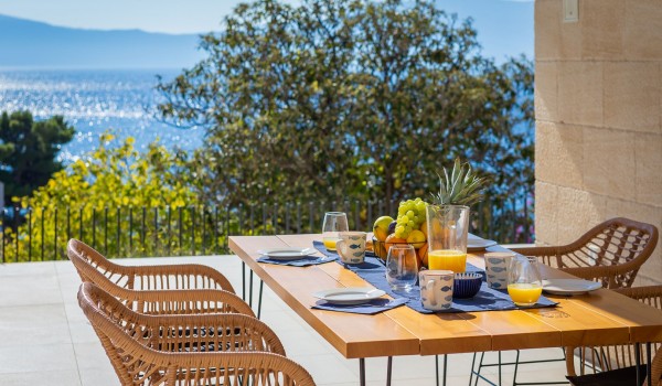 Outdoor dining area near pool of holiday luxury villa Azul in Makarska for vacation and rent.