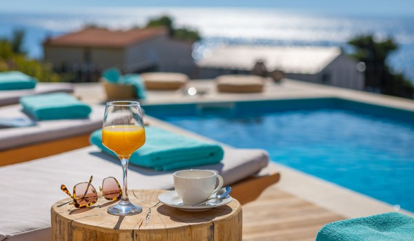 Sunbathing area with outddoor furnitrue by the pool of family luxury villa Makarska for vacation and rent.