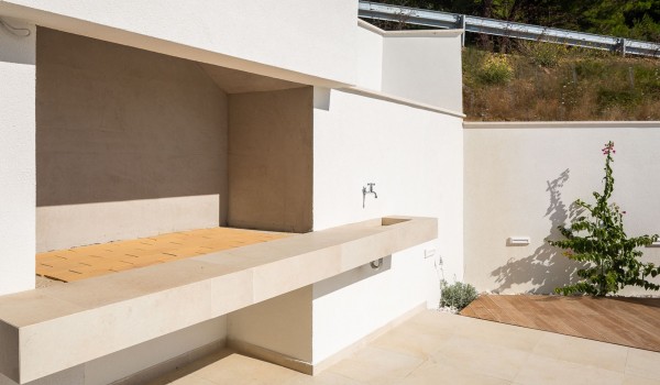 Outdoor stone hearth of holiday luxury private villa Makarska with pool and sea view.