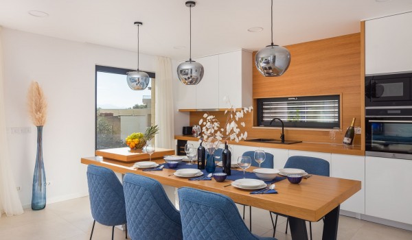 Dining table with utensils and fully equipped kitchen in Makarska luxury vila Azul with pool and sea view.