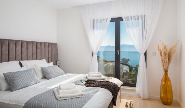 Spacious bedroom with King-size bed and en suite bathroom in luxury villla Makarska for vacation and rent.