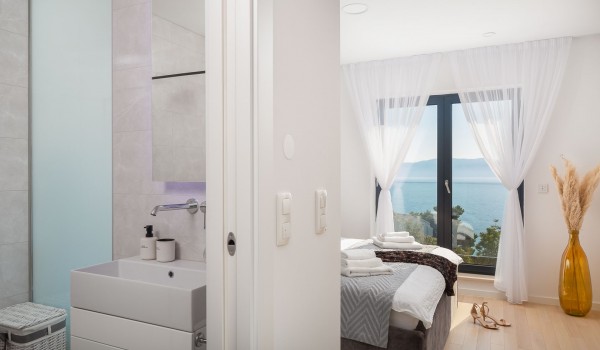 Spacious bedroom with King-size bed and en suite bathroom in luxury villla Makarska for vacation and rent.
