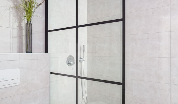 En suite white bathroom with walk-in shower in Makarska luxury modern villa with pool and sea view.