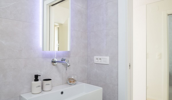 En suite white bathroom with walk-in shower in Makarska luxury modern villa with pool and sea view.