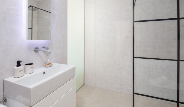 En suite white bathroom with walk-in shower in Makarska luxury modern villa with pool and sea view.