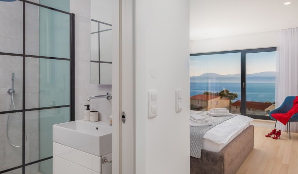 En suite white bathroom with walk-in shower in Makarska luxury modern villa with pool and sea view.
