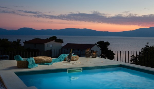 Outdoor pool with outdoor furniture in Makarska luxury beachfront villa for vacation and rent.