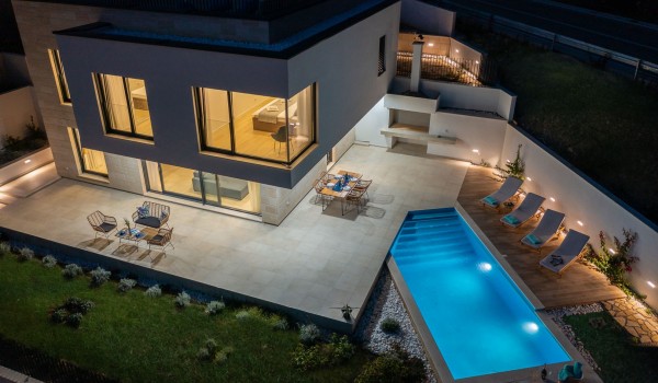 Night picture of property of modern luxury villa Azul in Makarska by the beach with private pool.