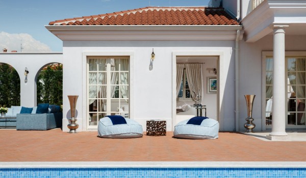 Sunbeds next to the private pool on the outdoor terrace of the luxury holiday villa Lea in the town of Vabriga in Istria