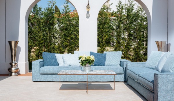 Comfortable sofa with a small table on the outdoor terrace of the luxury holiday villa Lea in Vabriga in Istria