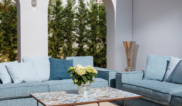 Sitting blue sofa decorated with cushions on the outdoor terrace of the luxury villa Lea in Vabriga in Istria