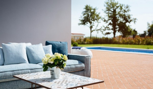 View from the seating area of the private pool and landscape green lawn in the luxury holiday villa Lea in Vabriga in Istria