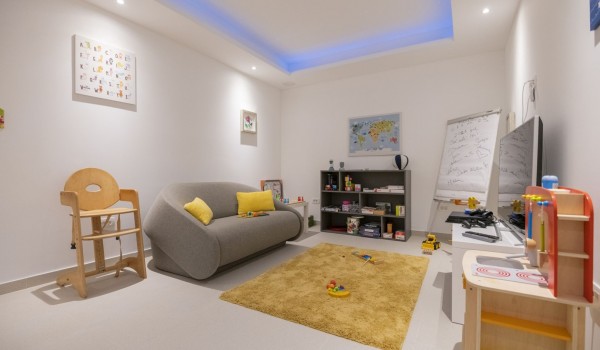 Children's chair, children's kitchen and sofa and LCD TV in the entertainment room in the luxurious villa with private pool Glorious Brela in Brela
